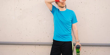 tired athletic man wiping sweat