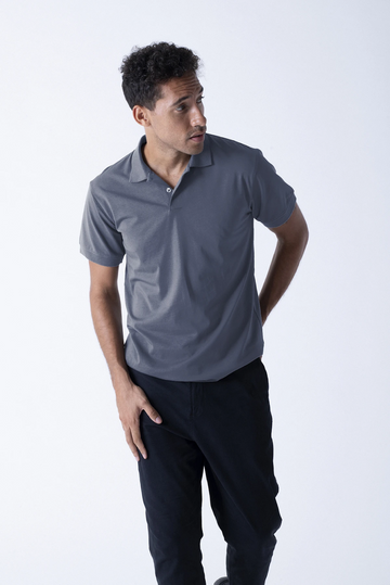 Three-quarter view of a gray polo shirt showcasing its short sleeves on a male model against a light background