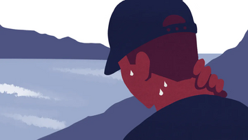 Person sweating heavily while wearing a cap in a mountainous outdoor setting