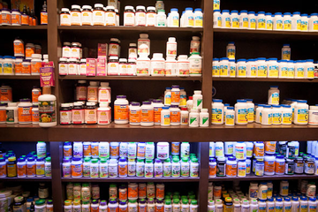 Assorted vitamin and mineral supplement bottles arranged on retail shelves
