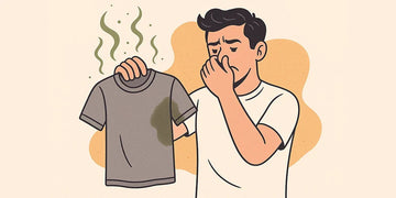 Man holds a gray shirt with odor lines while covering his nose against a beige background