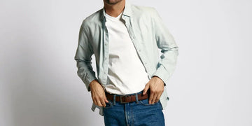 Front view of a white undershirt showcasing its layered fit beneath an open shirt against a plain background
