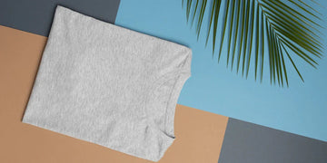 Angled view of gray undershirt showcasing its sleeveless design with a geometric blue and tan background