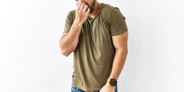 Man standing isolated white background smelling and holding breath with fingers nose