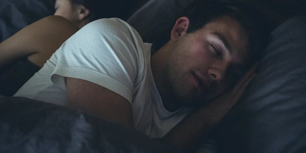 Couple sleeping on bed in the bedroom