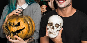 Amused friends with halloween attributes