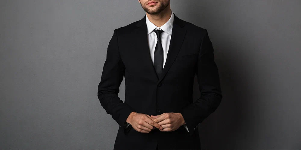Close-up photo of young man in black suit.
