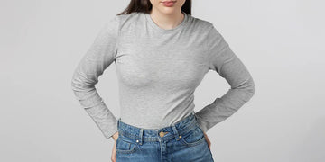 Girl wearing Long sleeve grey undershirt posing in studio