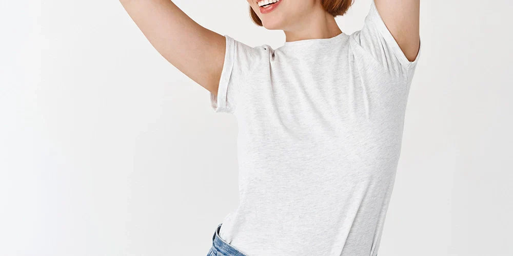 Portrait of beautiful candid girl with natural light makeup raising hands up and looking aside with carefree smile