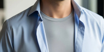 Slim-fit sweat-proof undershirt sitting flat under a dress shirt for better sweat control.