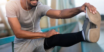 Young smiling man preparing for running