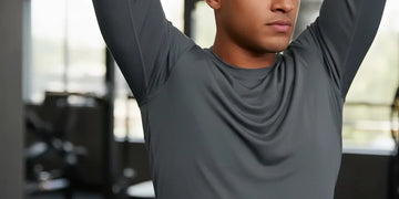 Performance shirt stretching across shoulders during overhead movement.