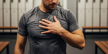 Man checking lightweight performance shirt that still feels damp after workout.