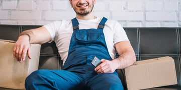 A shift worker sitting near boxes.
