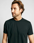 Front view of black crew neck shirt showcasing the neckline on a model with a light gray background