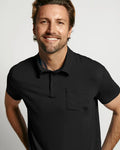 Front view of The Polo Power Pack showcasing a black short sleeve polo with chest pocket on a smiling model