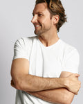 Three-quarter view of a white V-neck undershirt showcasing short sleeves on a male model against a gray background