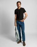 Front view of black V-neck T-shirt showcasing short sleeves on a model against a light gray background